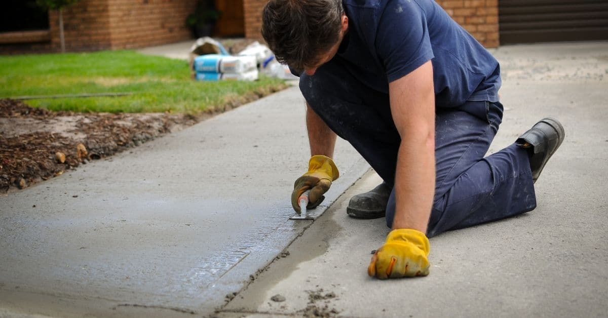 Concrete driveway with black strip expansion joint visible — Modern Yardz San Diego
