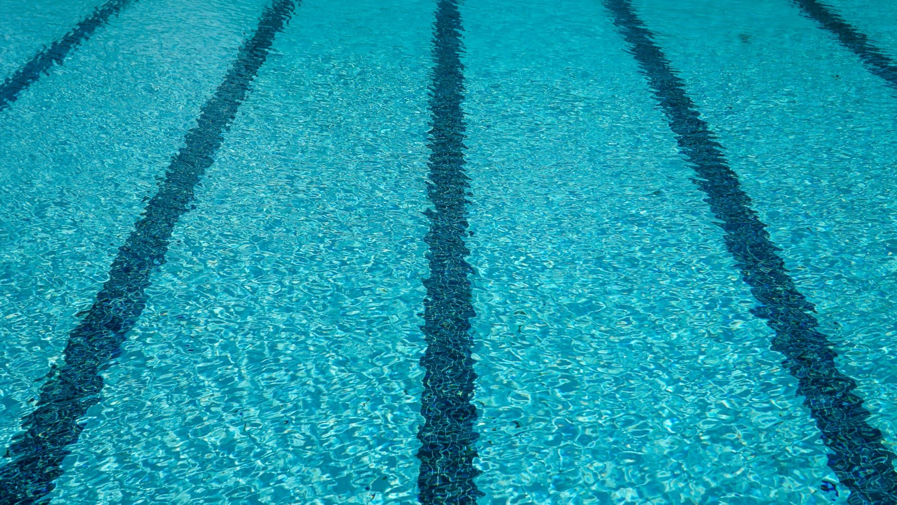 Close-up of clear blue swimming pool water, comparing saltwater and chlorine pool systems