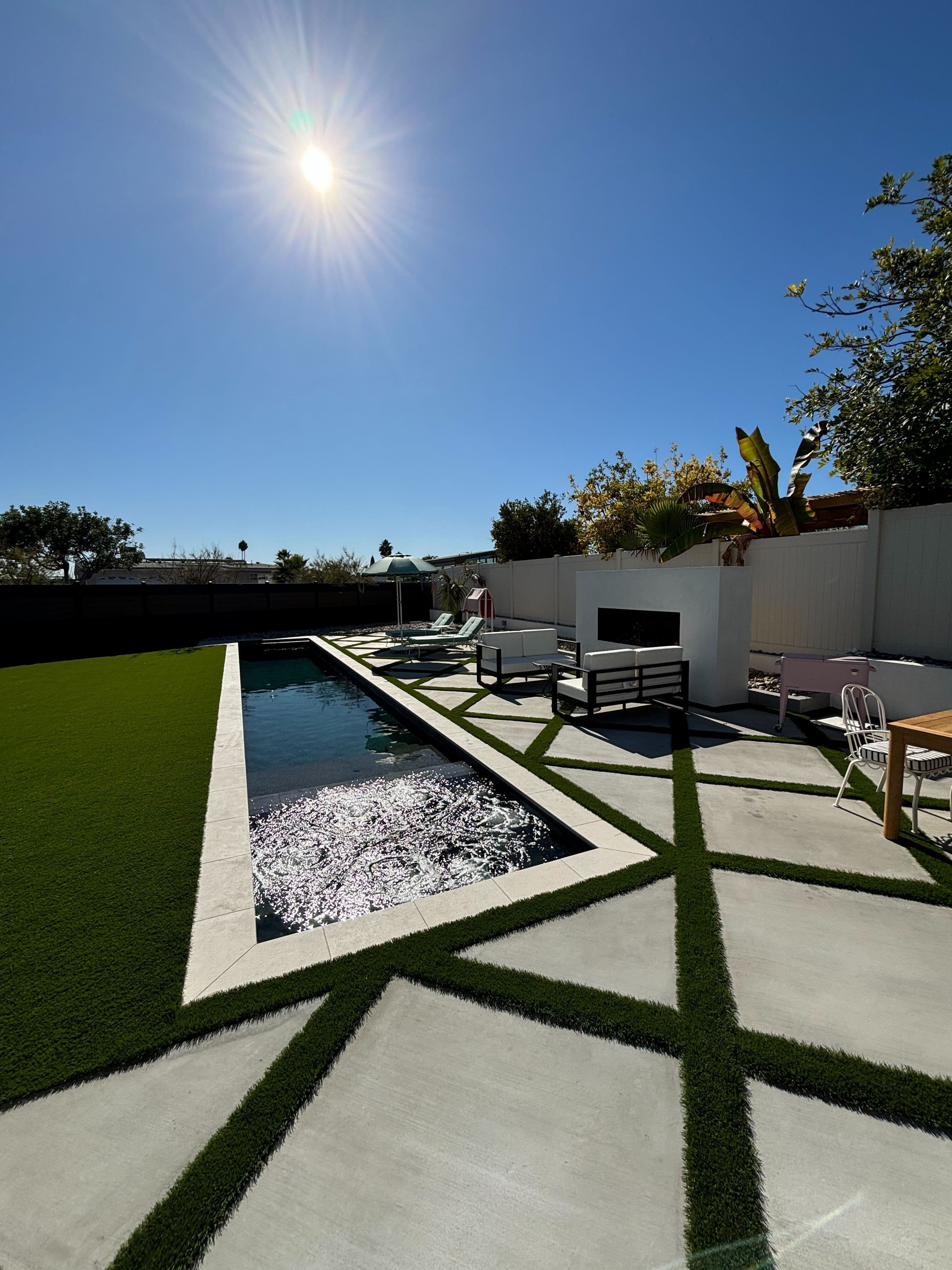 Artificial turf integrated with pool deck and hardscape