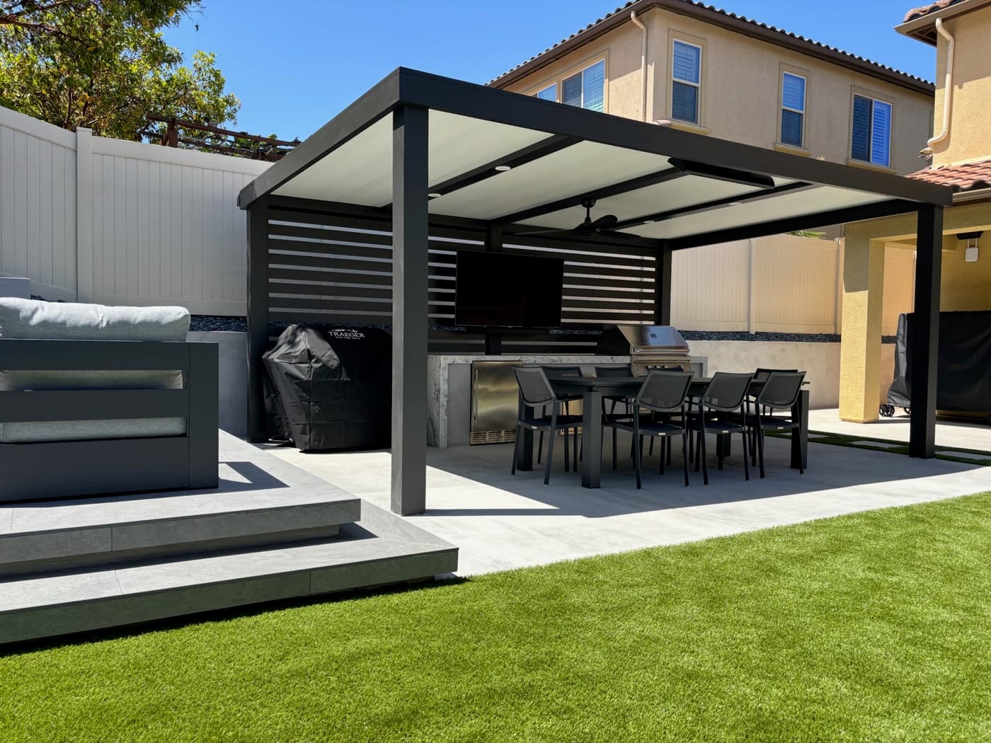 Louvered pergola dining and outdoor kitchen in Carlsbad by Modern Yardz