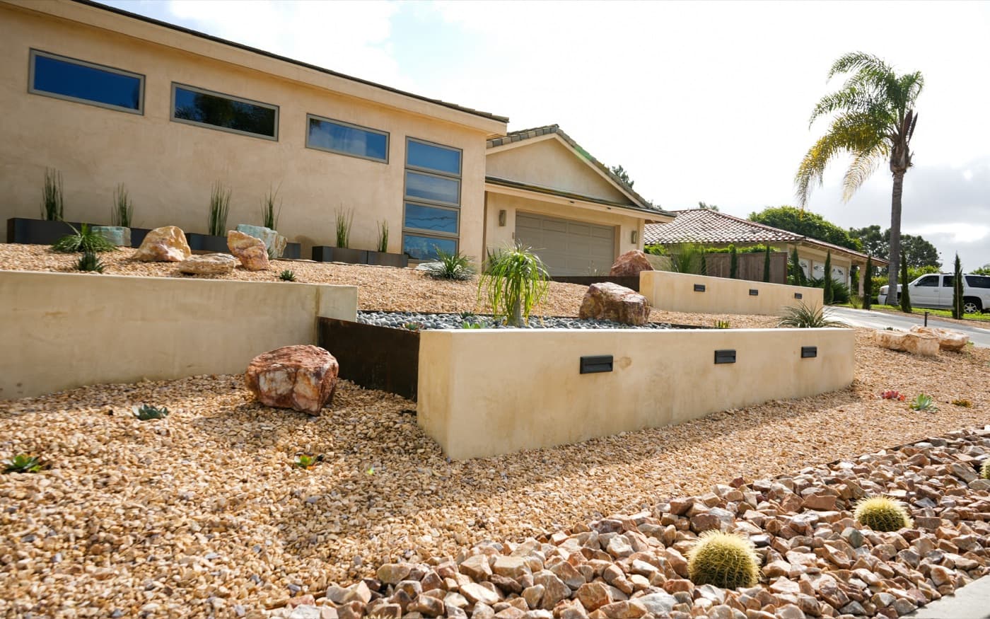 Drought-tolerant front yard with boulders in Oceanside by Modern Yardz
