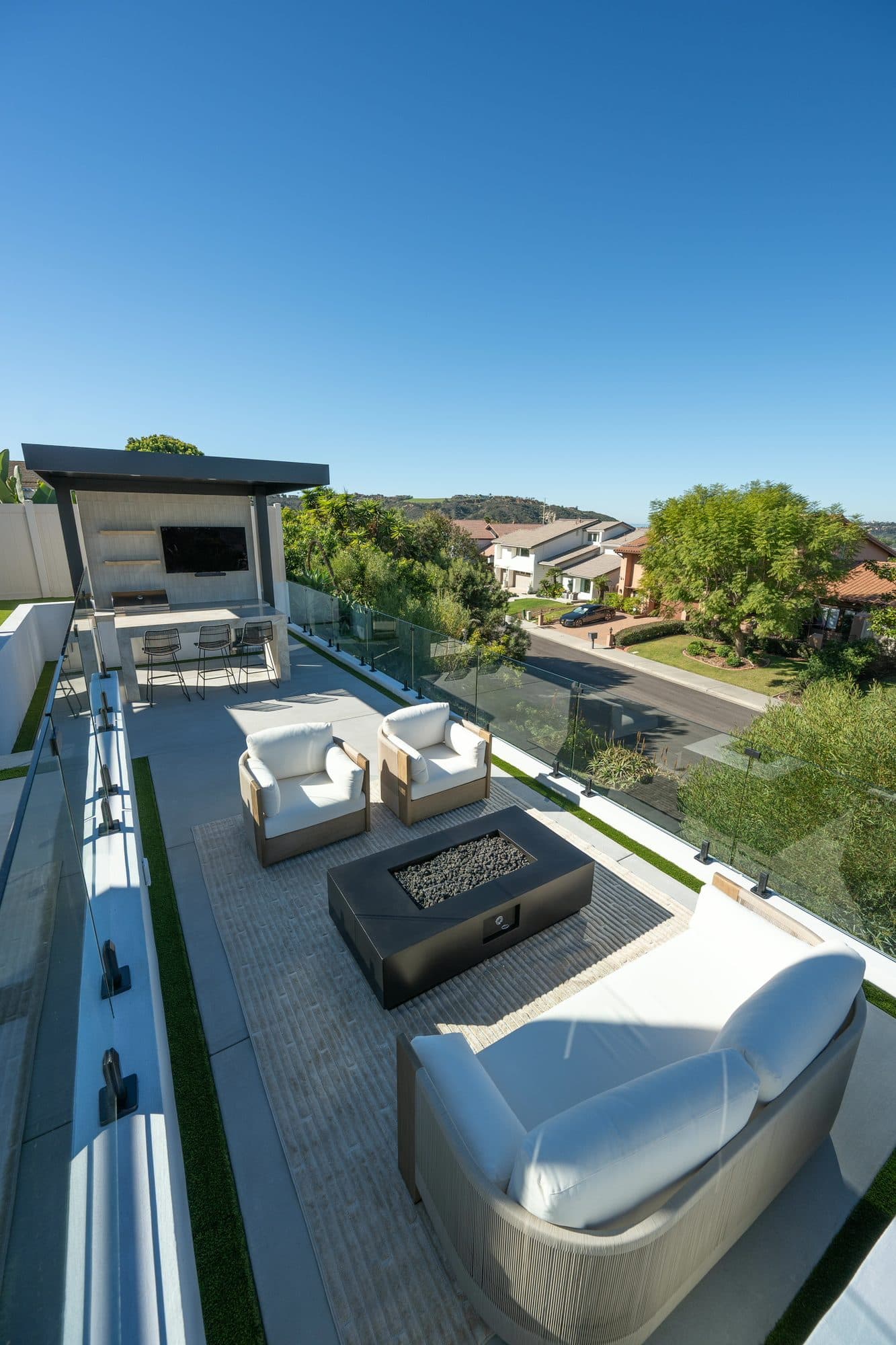 Fire-pit lounge with facing sofas overlooking the Carlsbad hillside