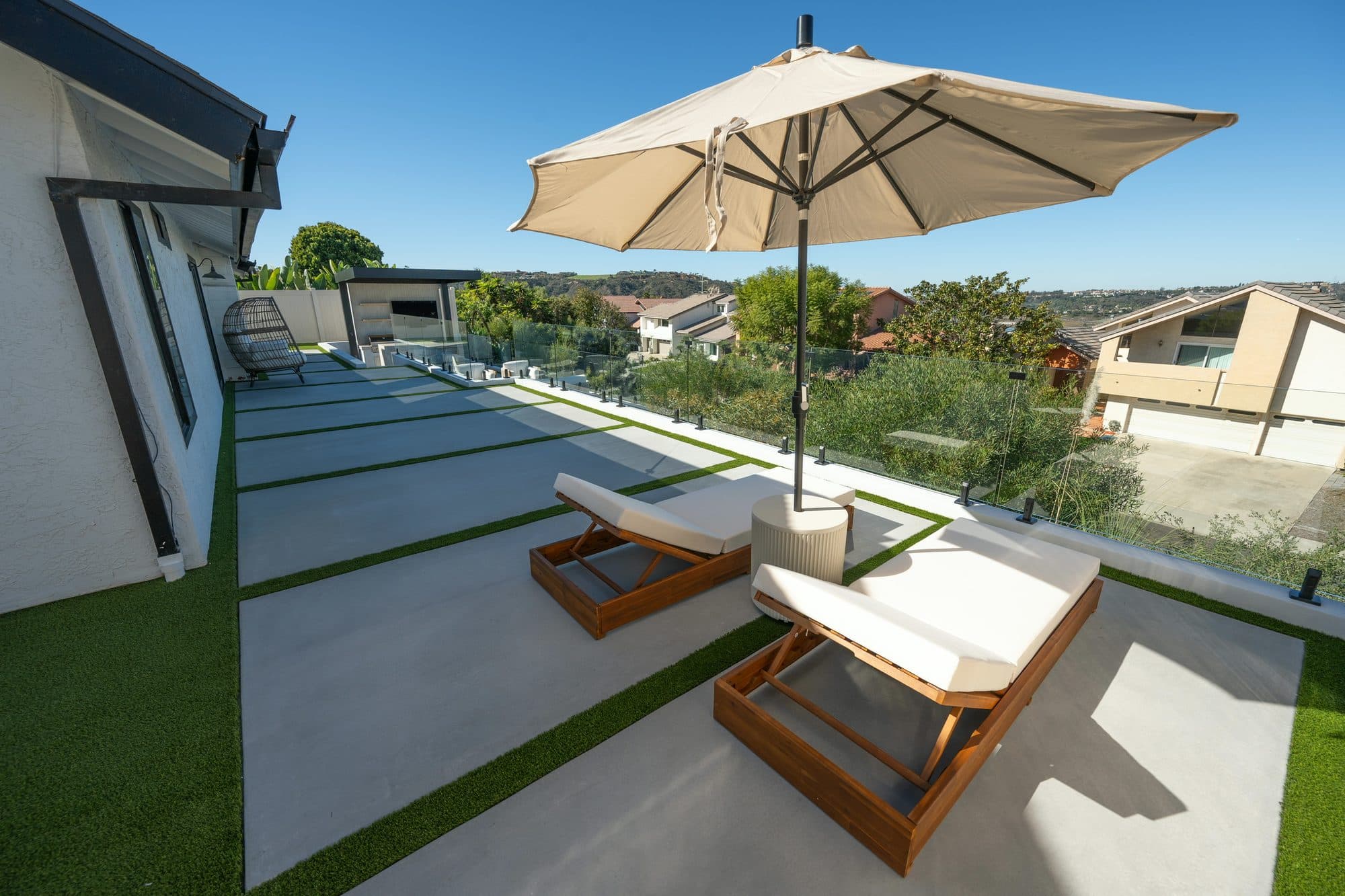 Concrete stepping-stone path and lounge area on a Carlsbad backyard rebuild by Modern Yardz