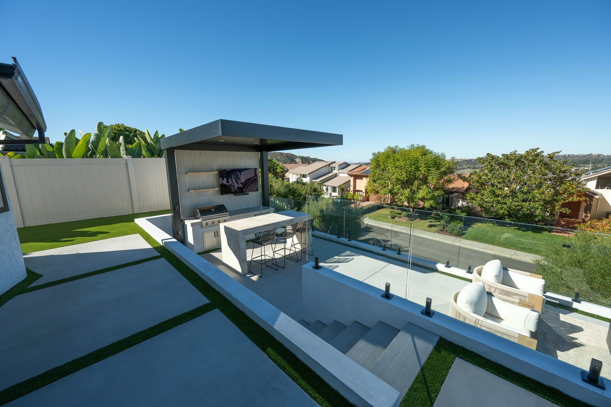 Custom retaining walls creating multiple levels on a sloped lot by Modern Yardz
