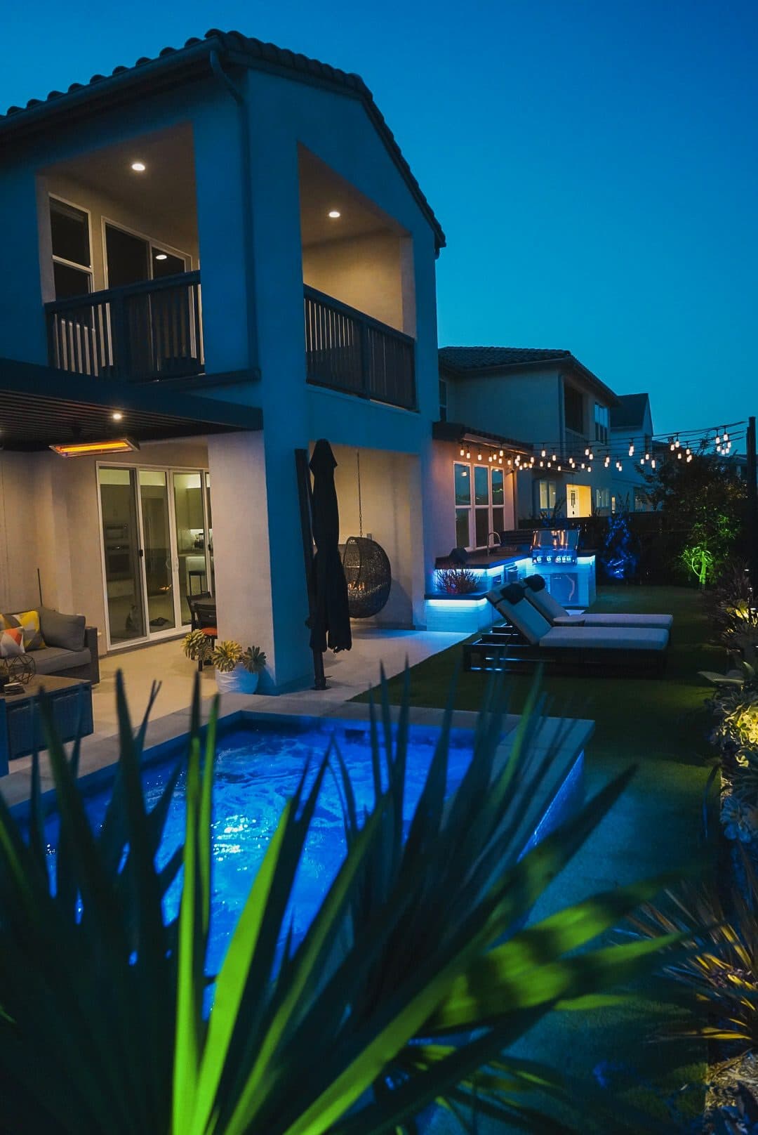 Twilight view of the home with the spool glowing blue