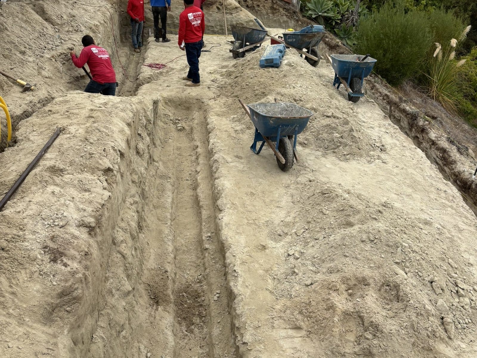 Modern Yardz crew excavating a sloped San Diego backyard at the start of a full remodel