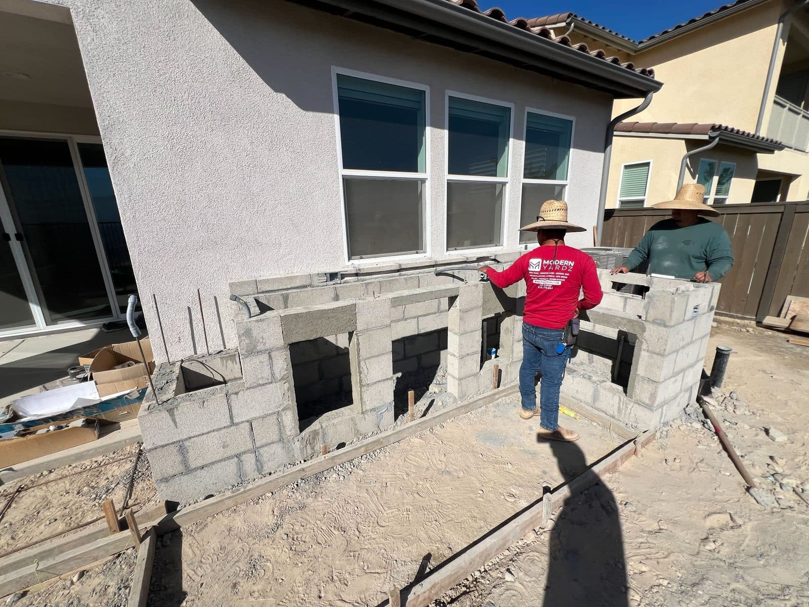 Modern Yardz masons building the block base of a custom outdoor kitchen in San Diego