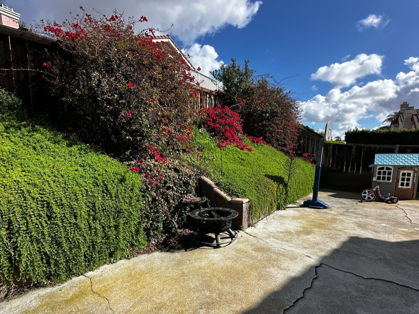 Cracked, stained concrete patio before replacement by Modern Yardz in San Diego