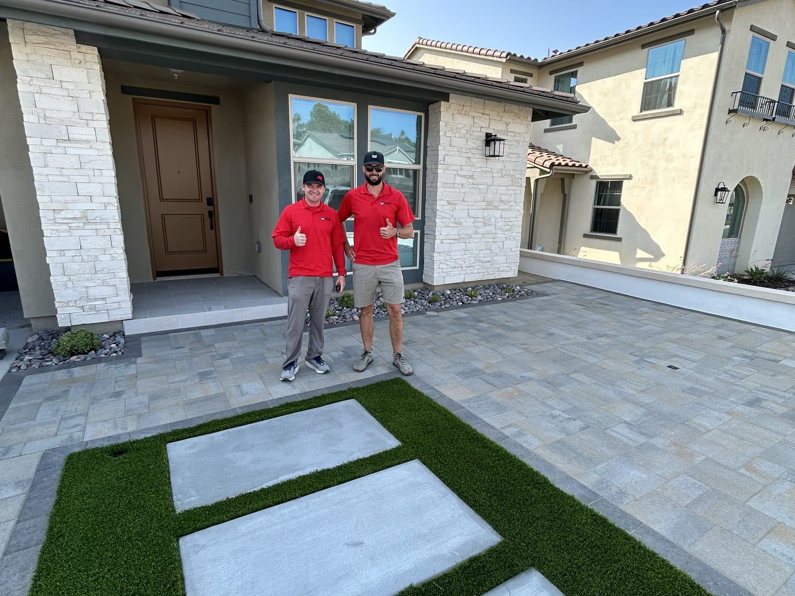 Paver driveway with artificial turf inlay and oversized concrete pads, installed by Modern Yardz in San Diego
